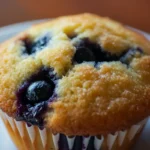 Delicious blueberry muffins bursting with fresh blueberries, inspired by the Blueberry Muffins strain aroma